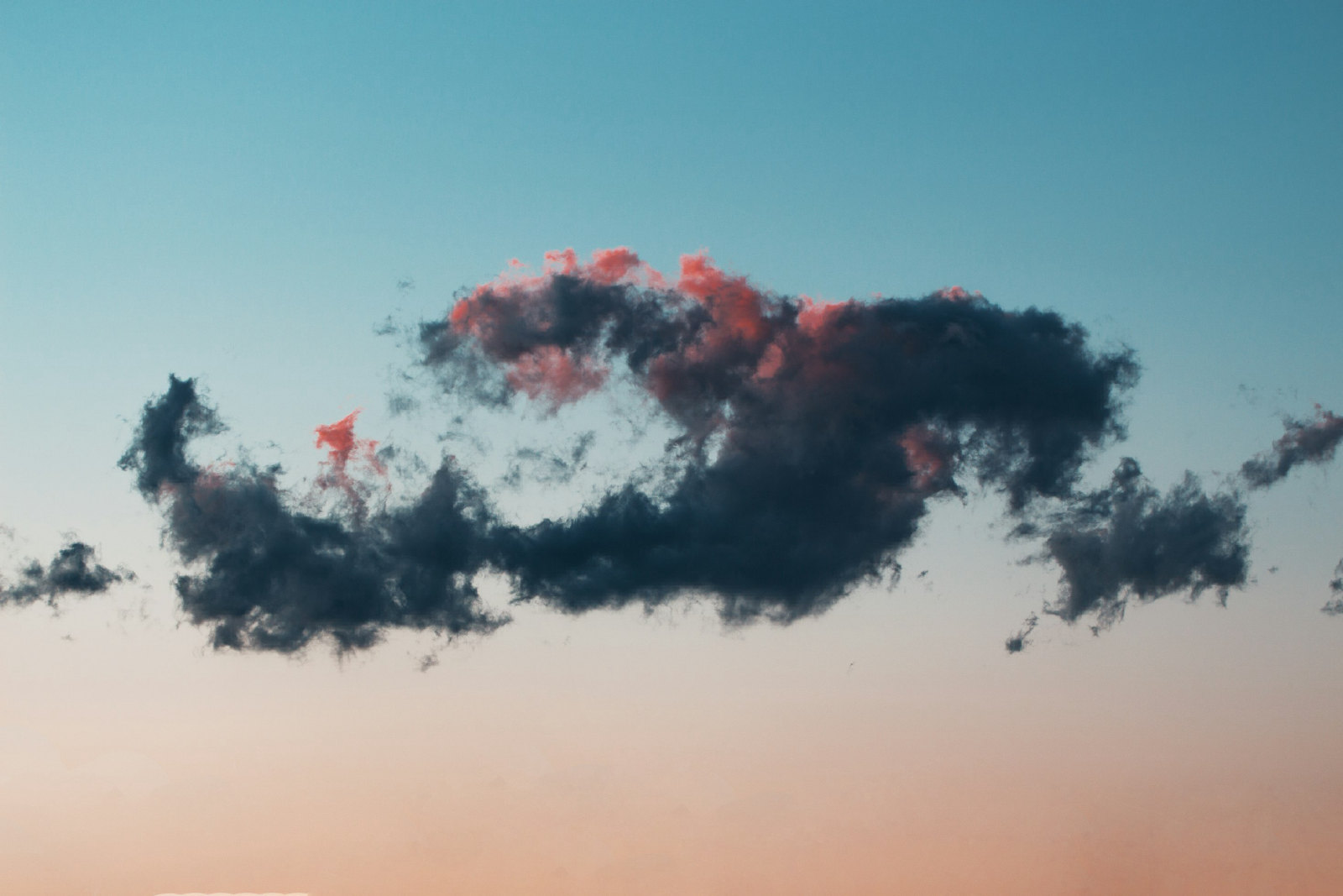 Billowing clouds drifting across a deep blue sky